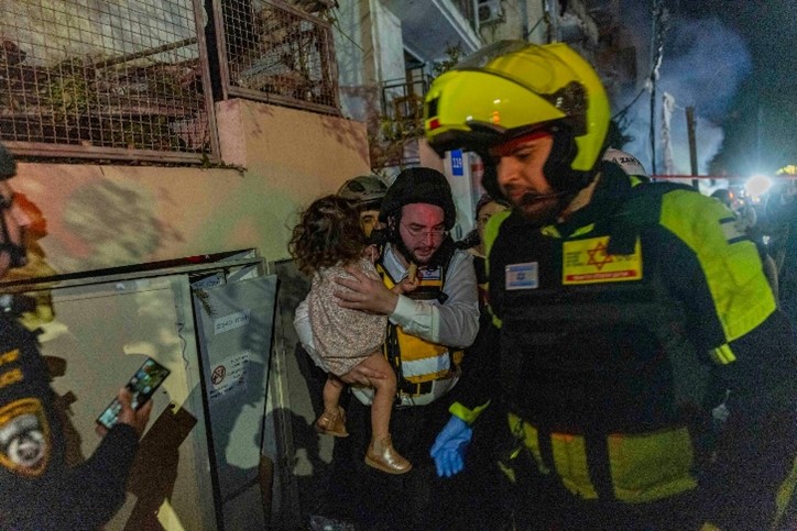 Rescue workers outside a Tel Aviv building damaged by fire from Iran Rescue workers outside a Tel Aviv building damaged by fire from Iran